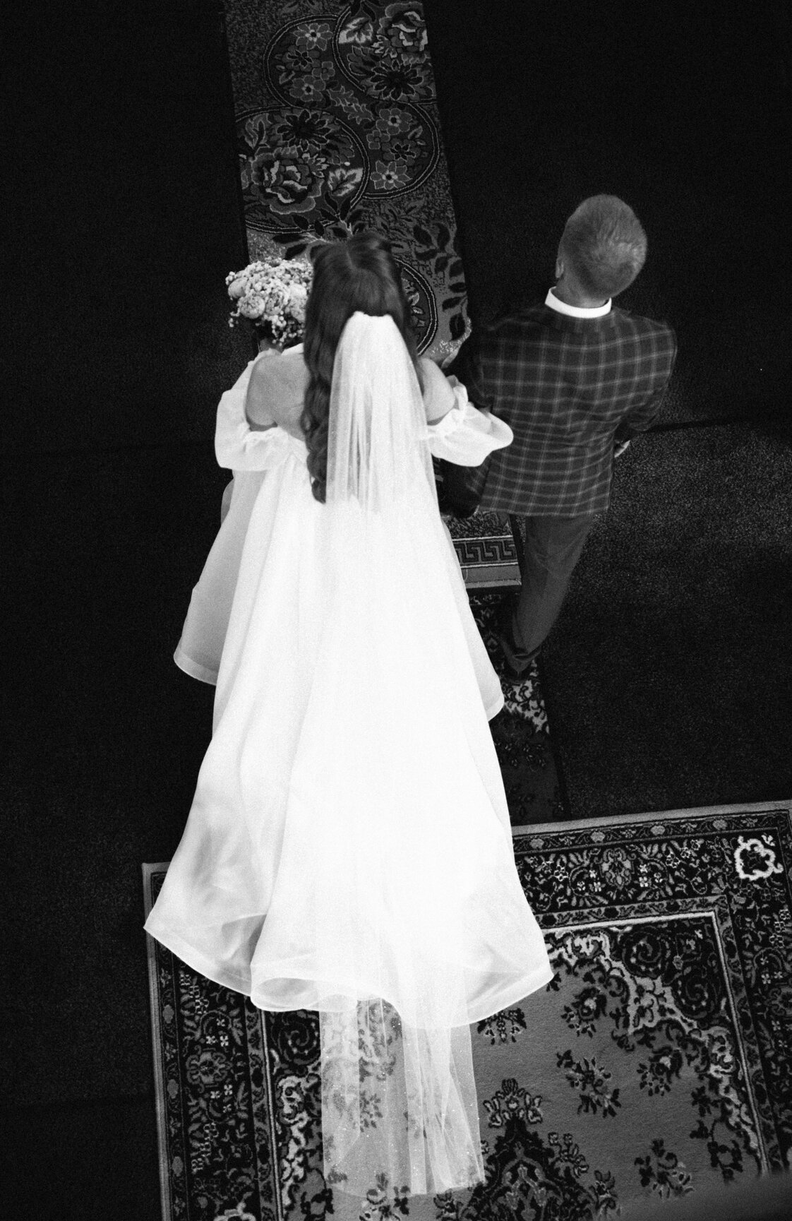 father guiding daughter to altar