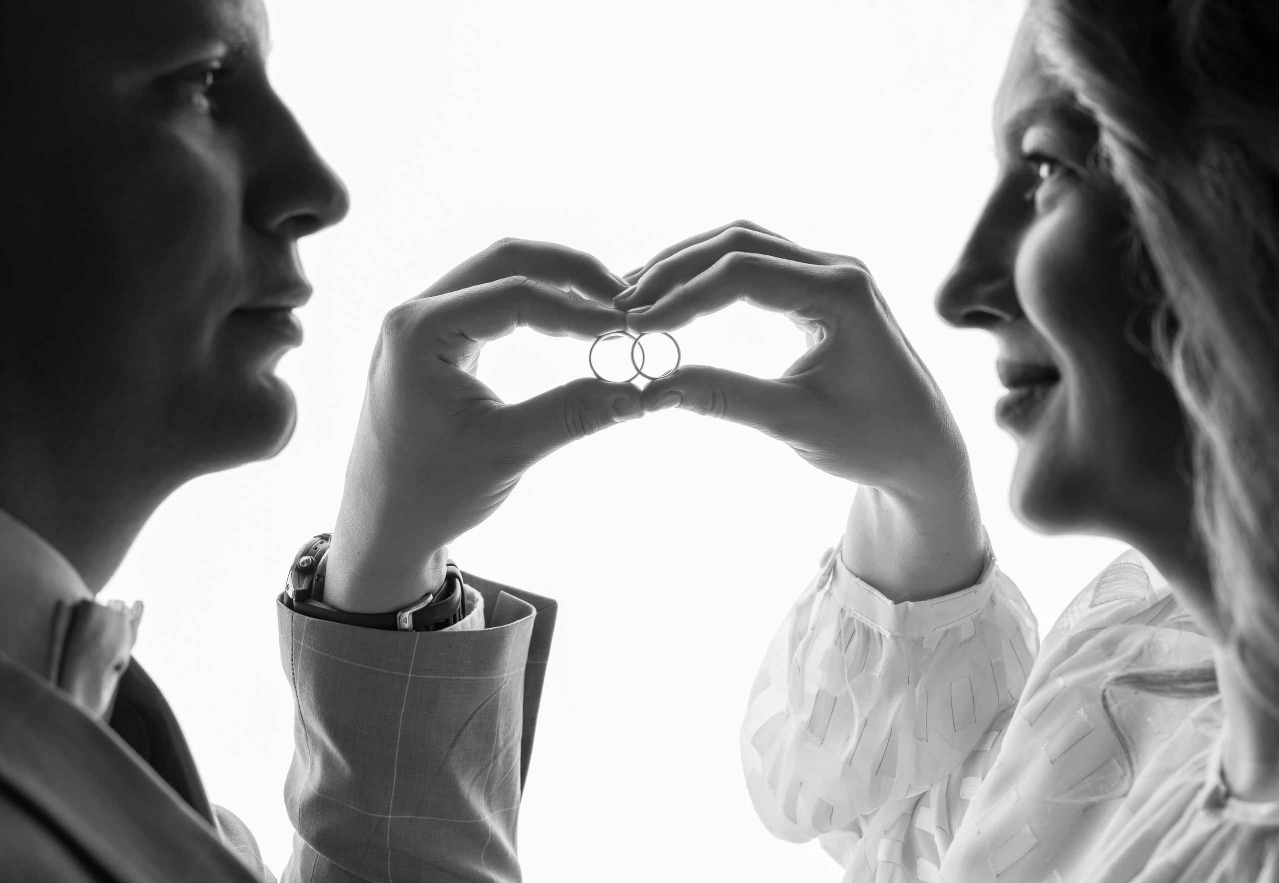 creative wedding photoshoot in studio couple holding rings