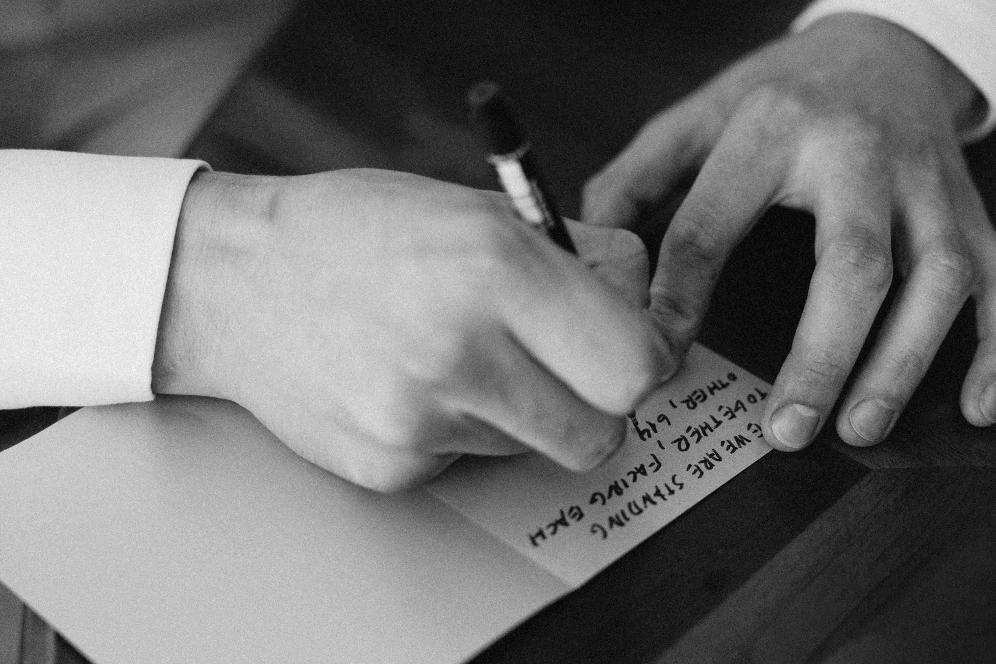 writing vows in morning close up of text and hand