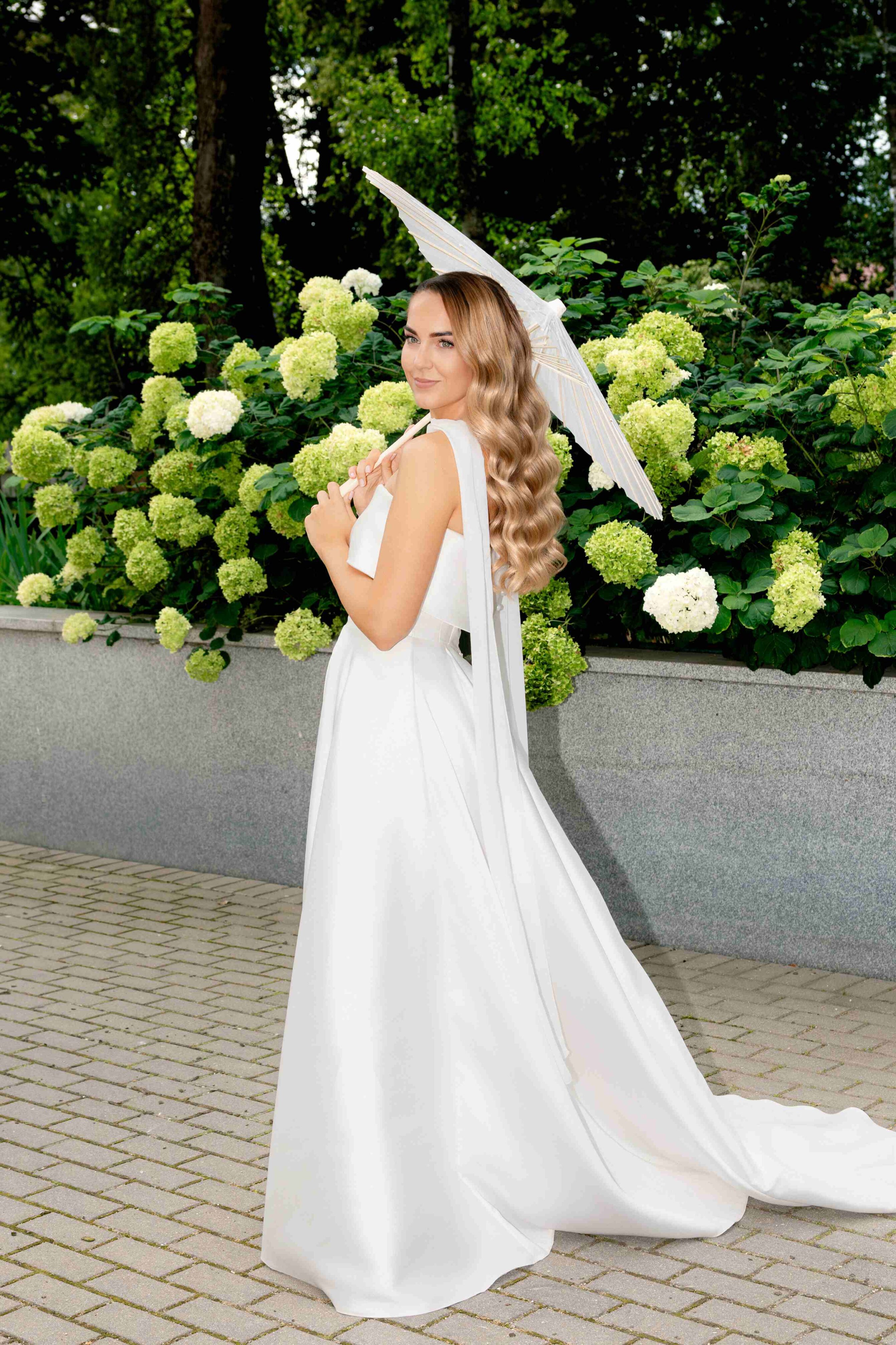 bride portrait in garden of hydrangea flowers paper umbrella