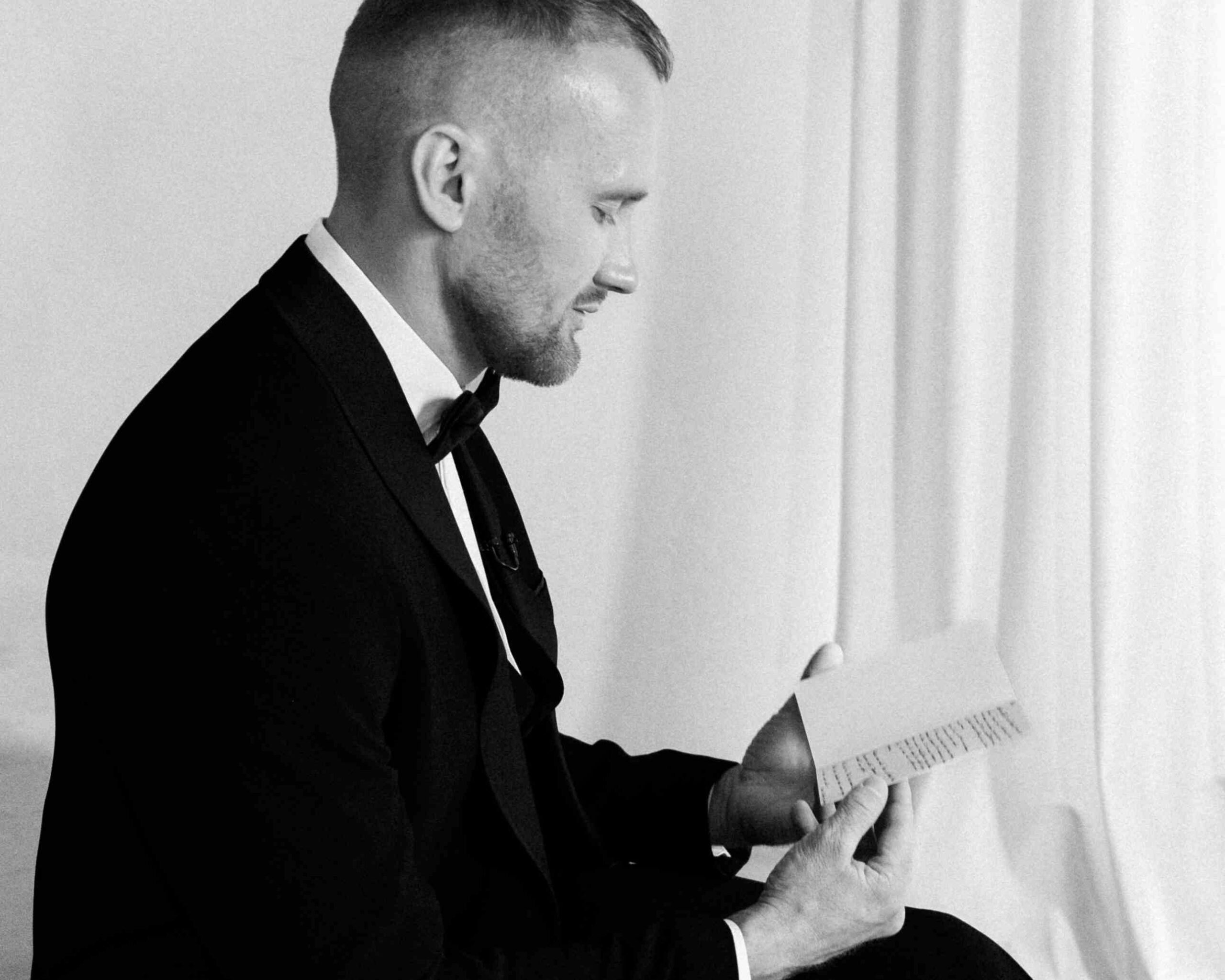 groom reading vows on morning