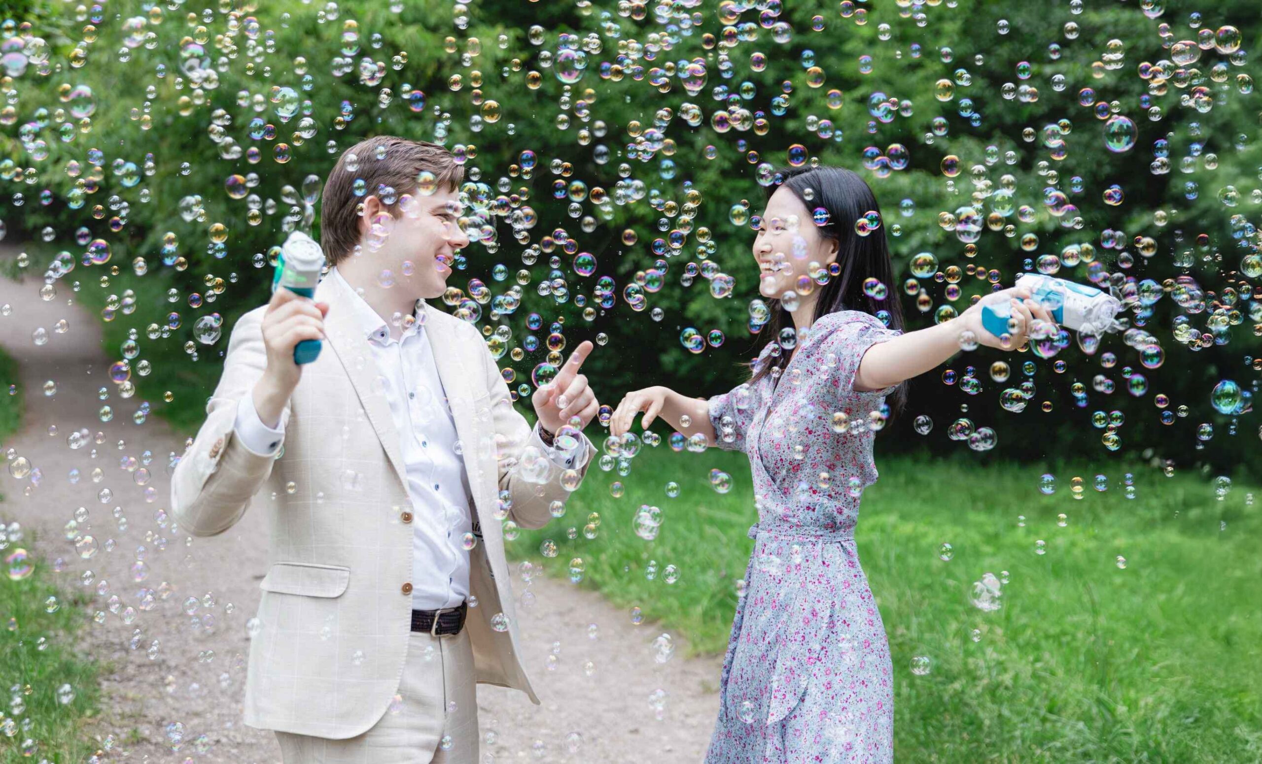 couple having fun bubble guns engagement
