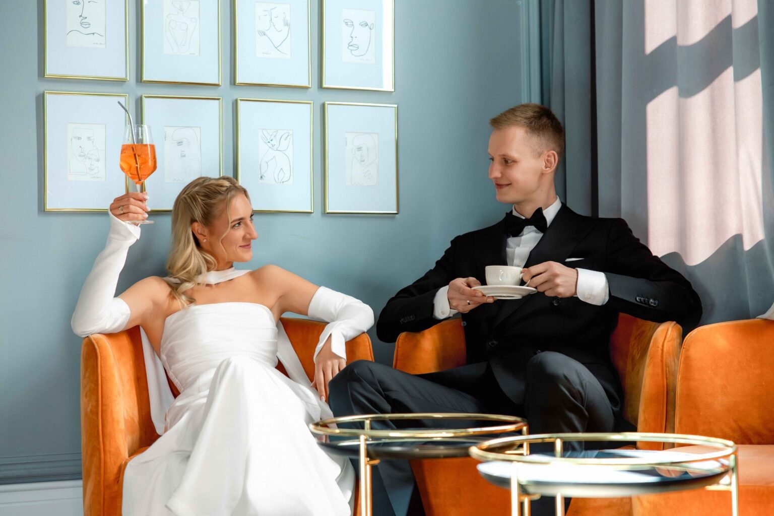 Bride and groom having tea and a spritz in a cosy hotel lounge