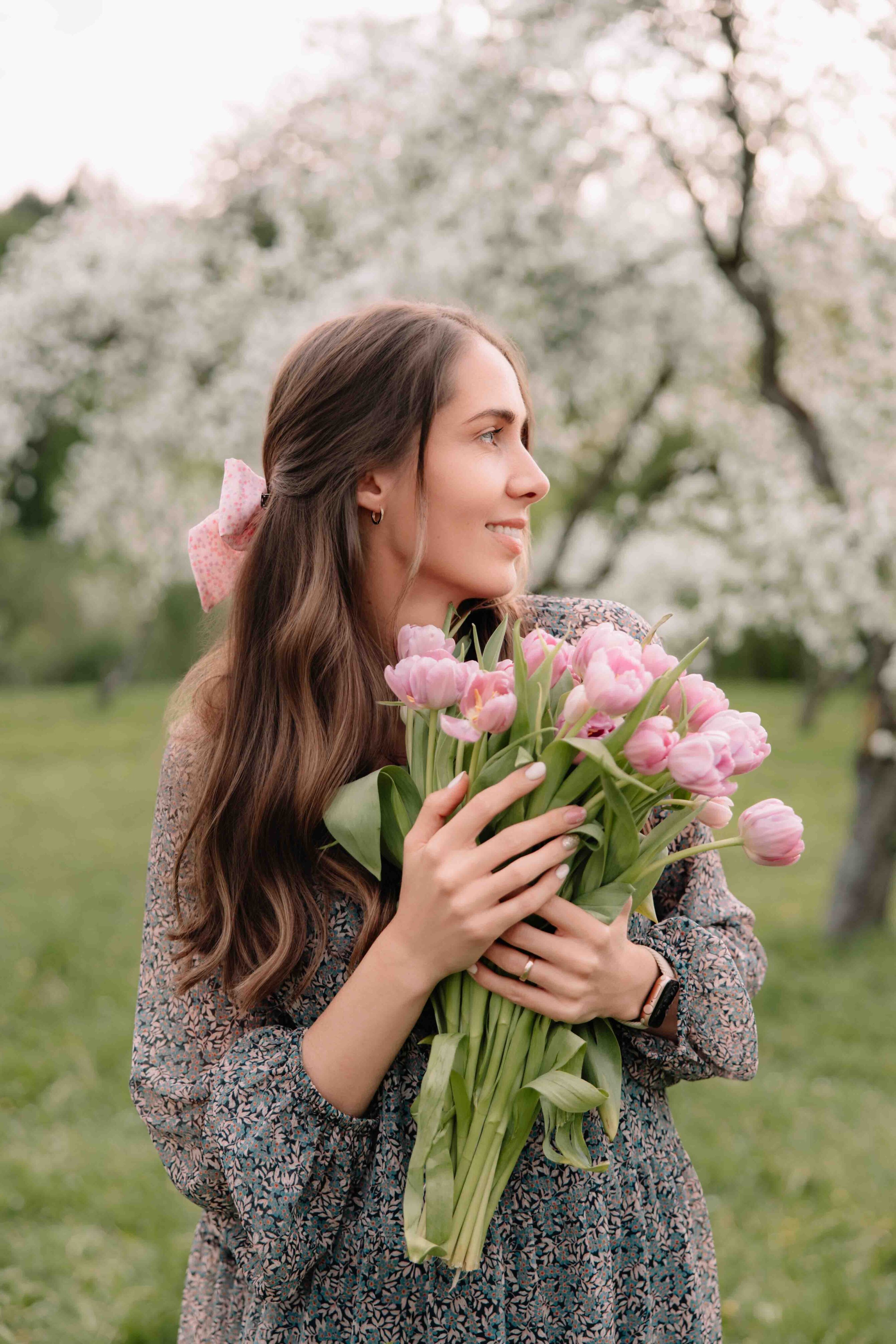 woman portrait with boquest of tulips amongst cherry blossoms