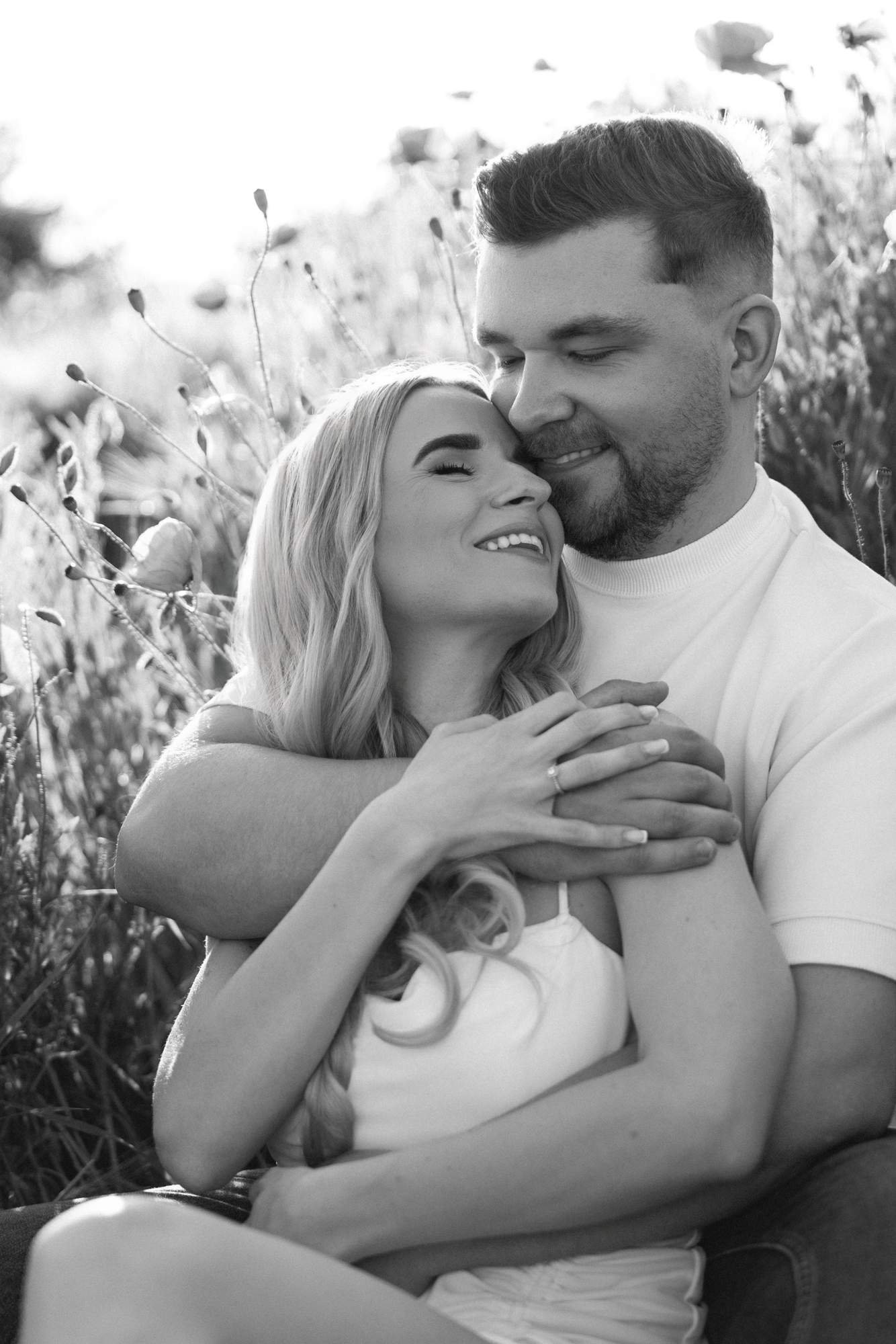 Couple hugging in a summer field, black and white photo