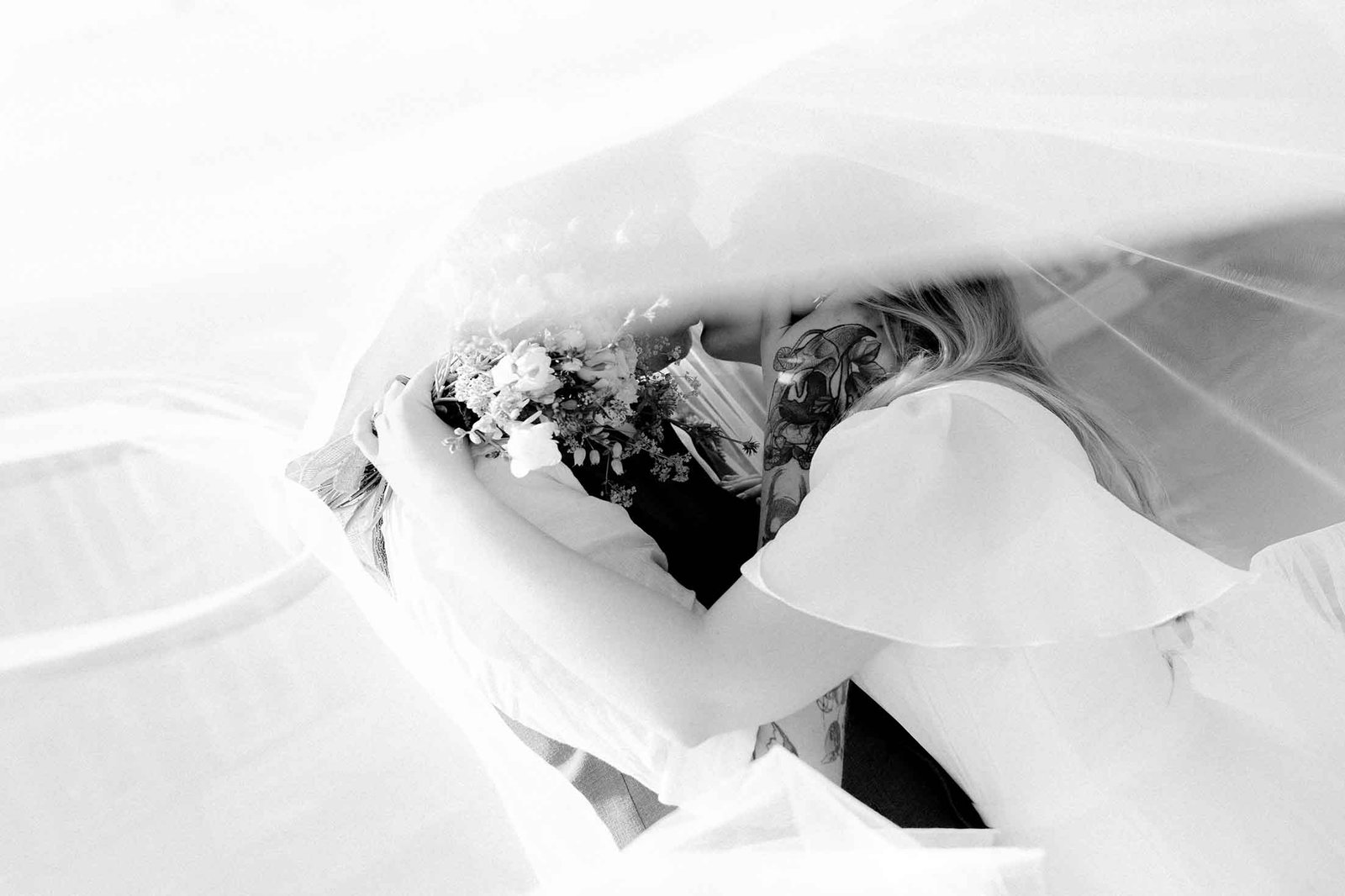 wedding portrait under veil no faces tattoed hands