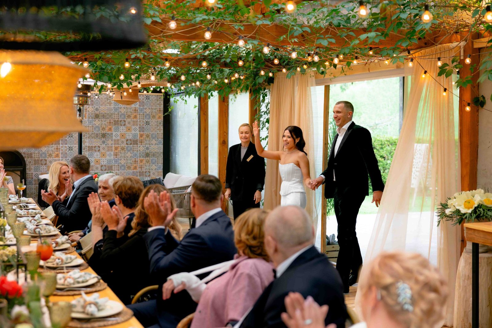 newlyweds coming to guests reception