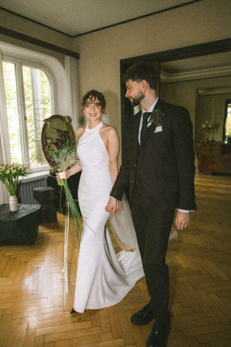 Bride and groom holding hands in a vintage interior