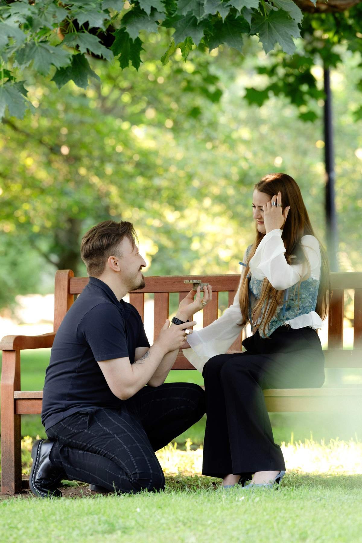 Brigita covering her mouth in shock the moment Evaldas proposed in Bernardinų Garden.