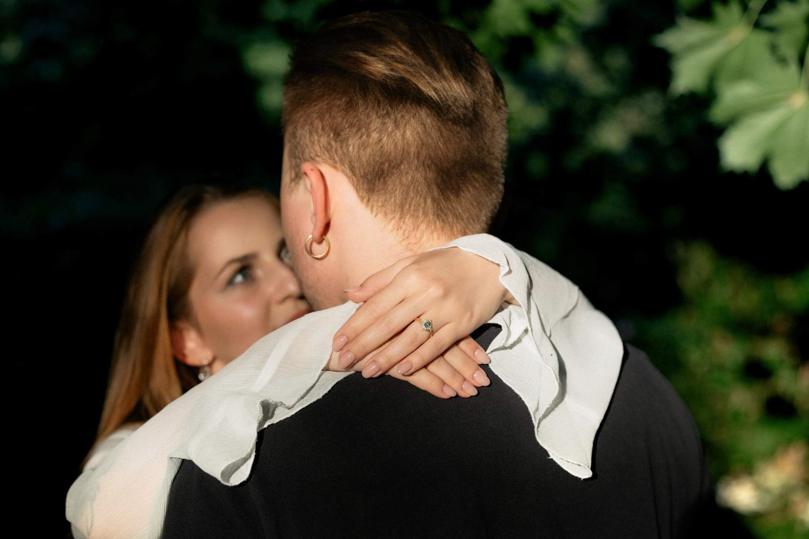 Evaldas kissing Brigita's cheek during their engagement session in the park.