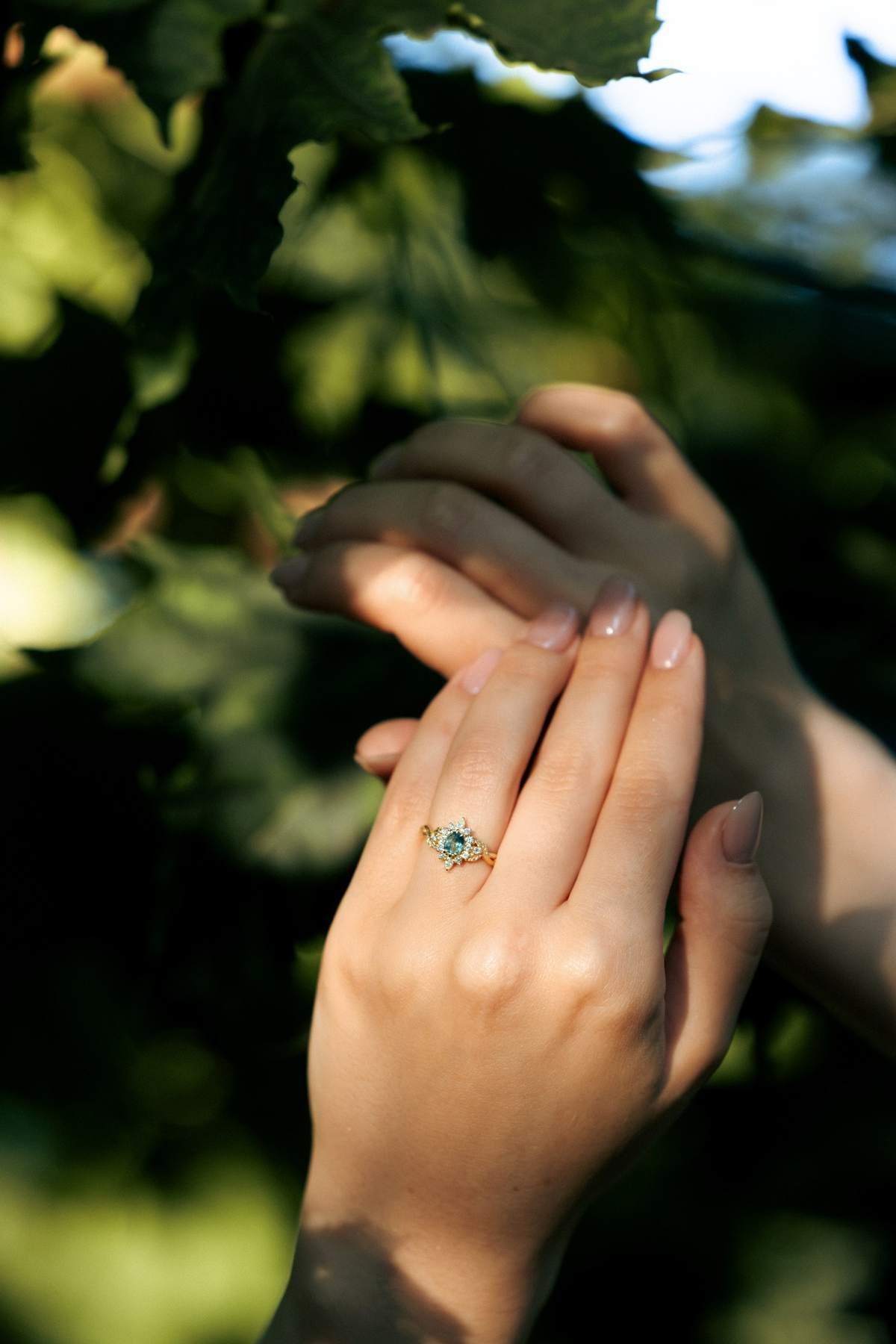 Close-up of the engagement ring as the newly engaged couple hold hands.