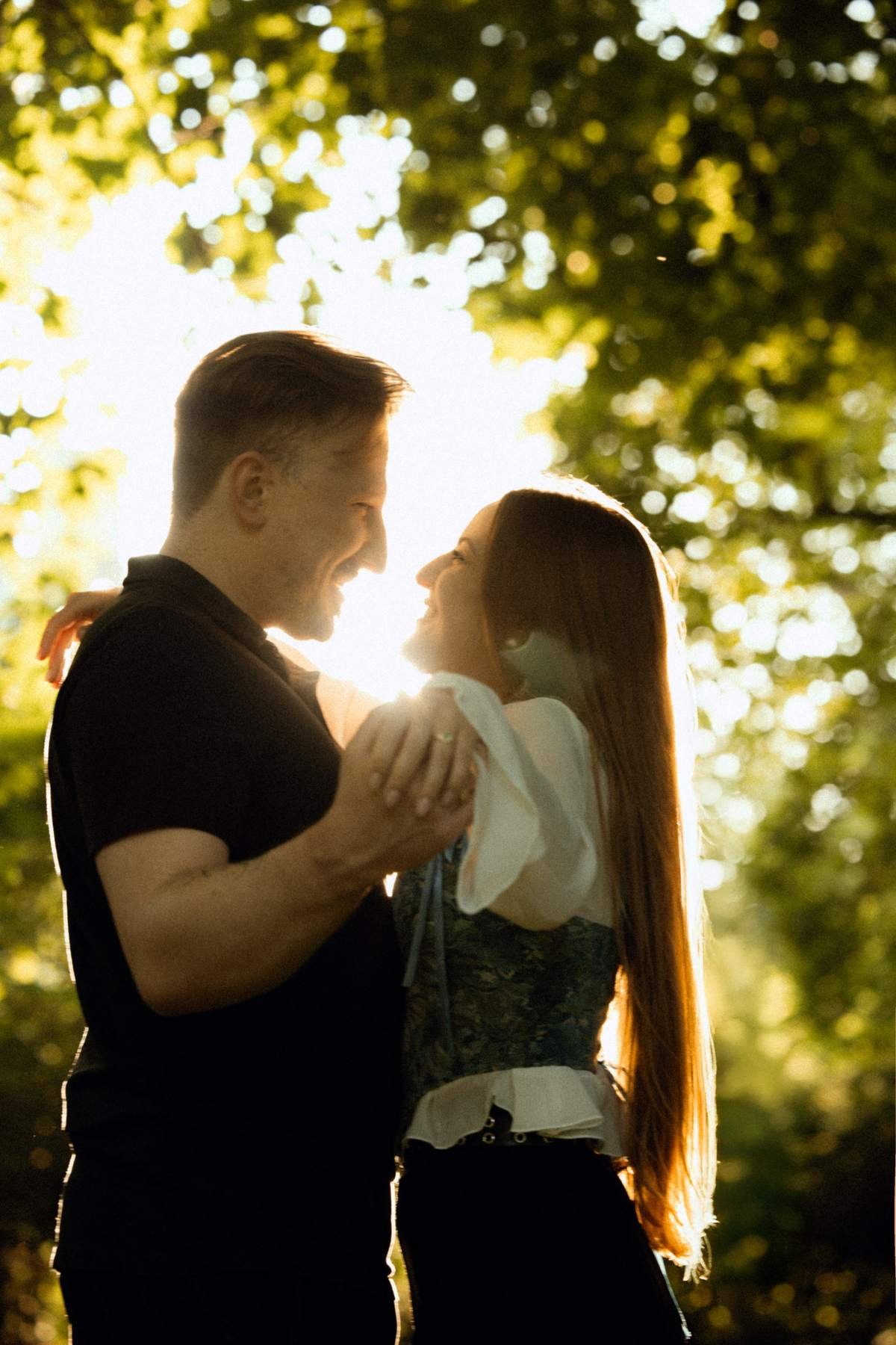 Golden hour engagement portrait of the couple in Bernardinų Garden, Vilnius.